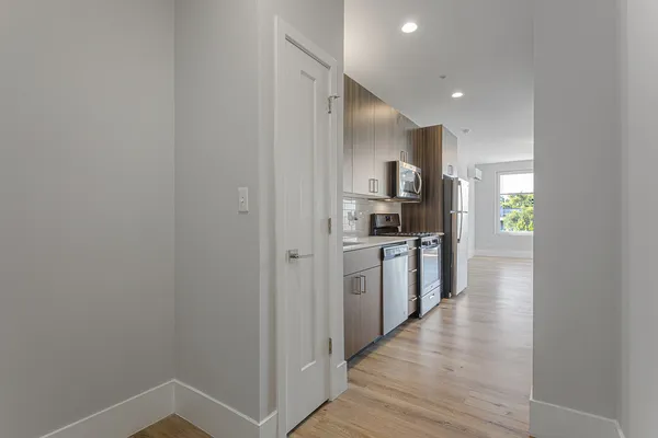 a kitchen with a refrigerator and a sink