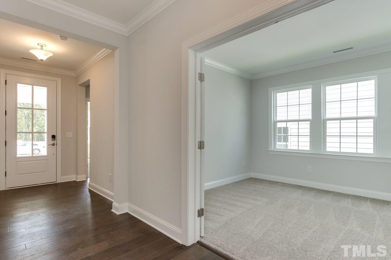244 Ivory Lane, Unit 72 Raleigh, NC 27610 - Photo 2 of 30 a view of an empty room with wooden floor and a window