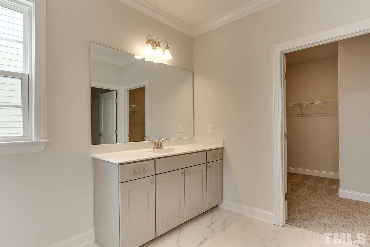 244 Ivory Lane, Unit 72 Raleigh, NC 27610 - Photo 15 of 30 a bathroom with a double vanity sink and a mirror