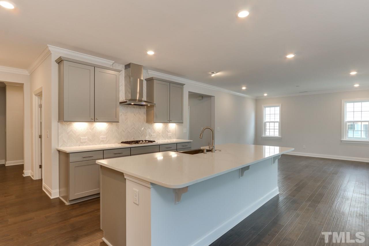 244 Ivory Lane, Unit 72 Raleigh, NC 27610 - Photo 5 of 30 a kitchen with stainless steel appliances granite countertop a sink a stove and a refrigerator
