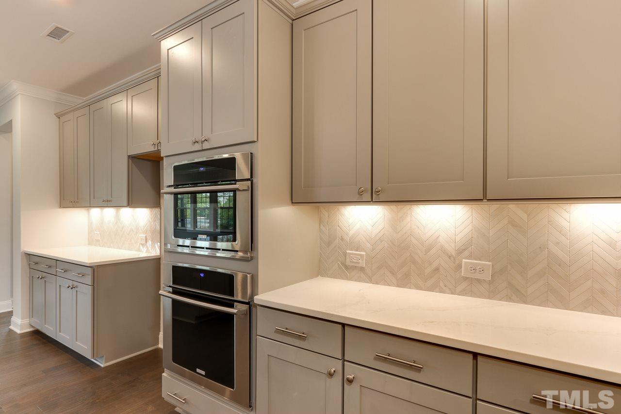 244 Ivory Lane, Unit 72 Raleigh, NC 27610 - Photo 6 of 30 a kitchen with cabinets and steel stainless steel appliances