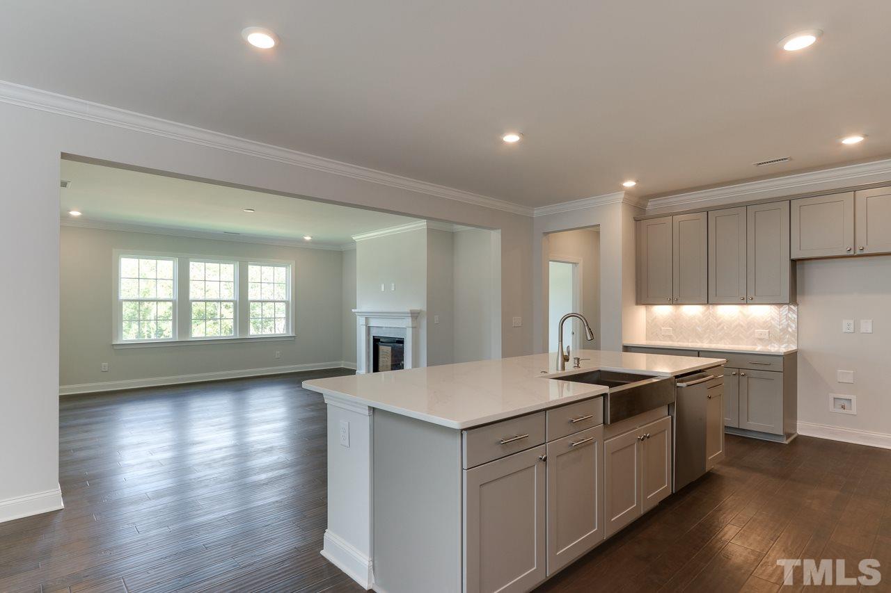 244 Ivory Lane, Unit 72 Raleigh, NC 27610 - Photo 8 of 30 a kitchen with granite countertop a sink stove and cabinets