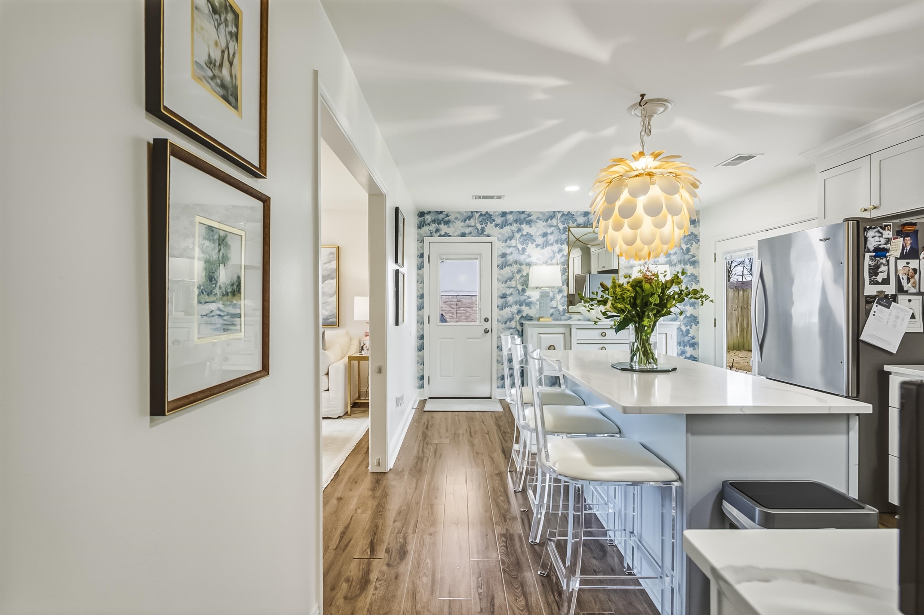 915 Greencliff Road Collierville, TN 38017 - Photo 16 of 32 a view of a dining room with furniture a chandelier and wooden floor