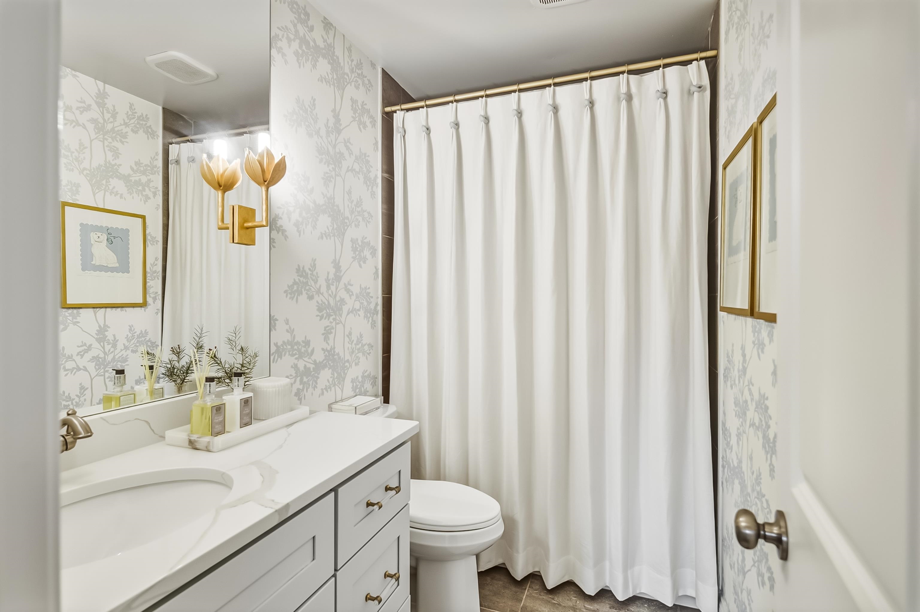 915 Greencliff Road Collierville, TN 38017 - Photo 19 of 32 a bathroom with a sink a toilet and shower curtain