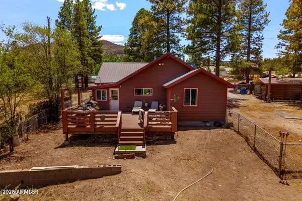a view of a house with a yard and sitting area