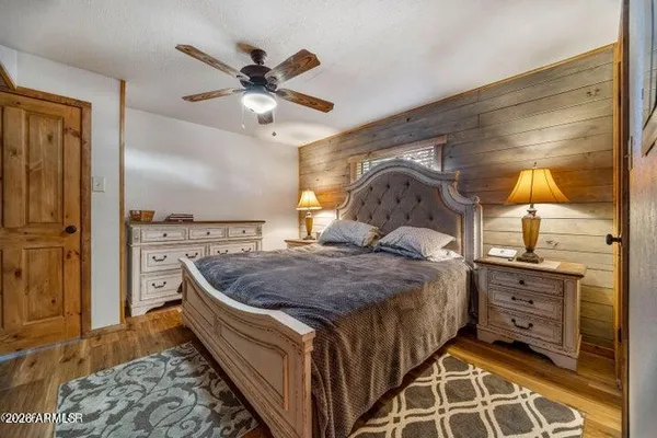 a bedroom with a bed and ceiling fan