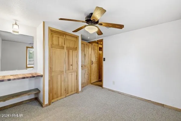 a view of a livingroom with a ceiling fan and window