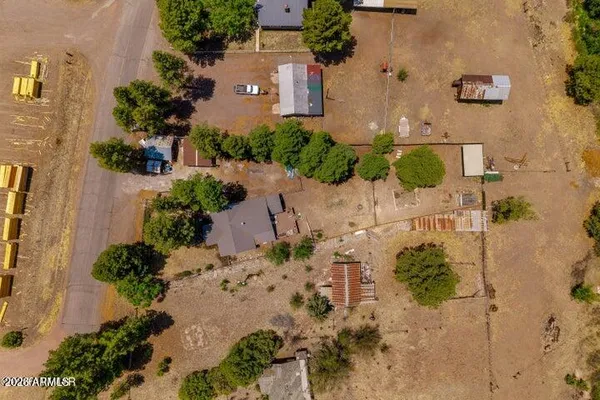 an aerial view of a house with a yard and garden