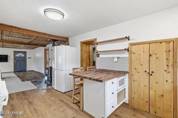 a kitchen that has a cabinets a sink and a refrigerator