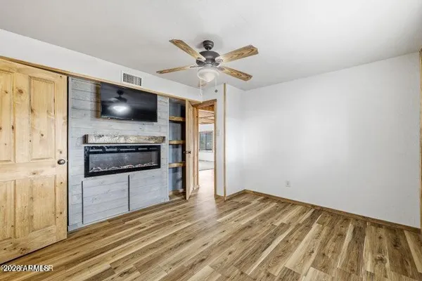 a view of a kitchen with a flat screen tv and refrigerator