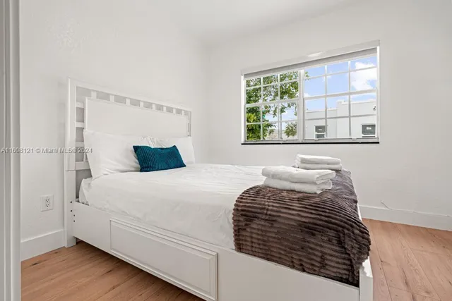 a bedroom with a bed and a window