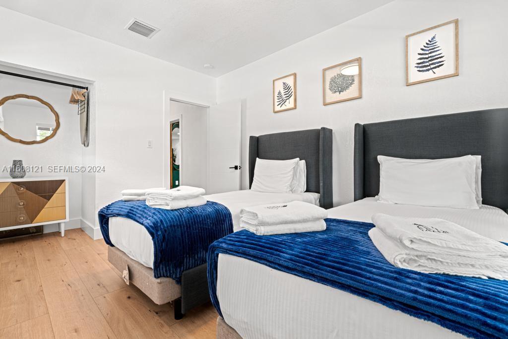 3902 Northwest 3rd Avenue Miami, FL 33127 - Photo 8 of 13 a bedroom with a bed and wooden floor