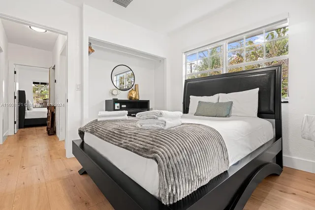 a bedroom with a bed and window