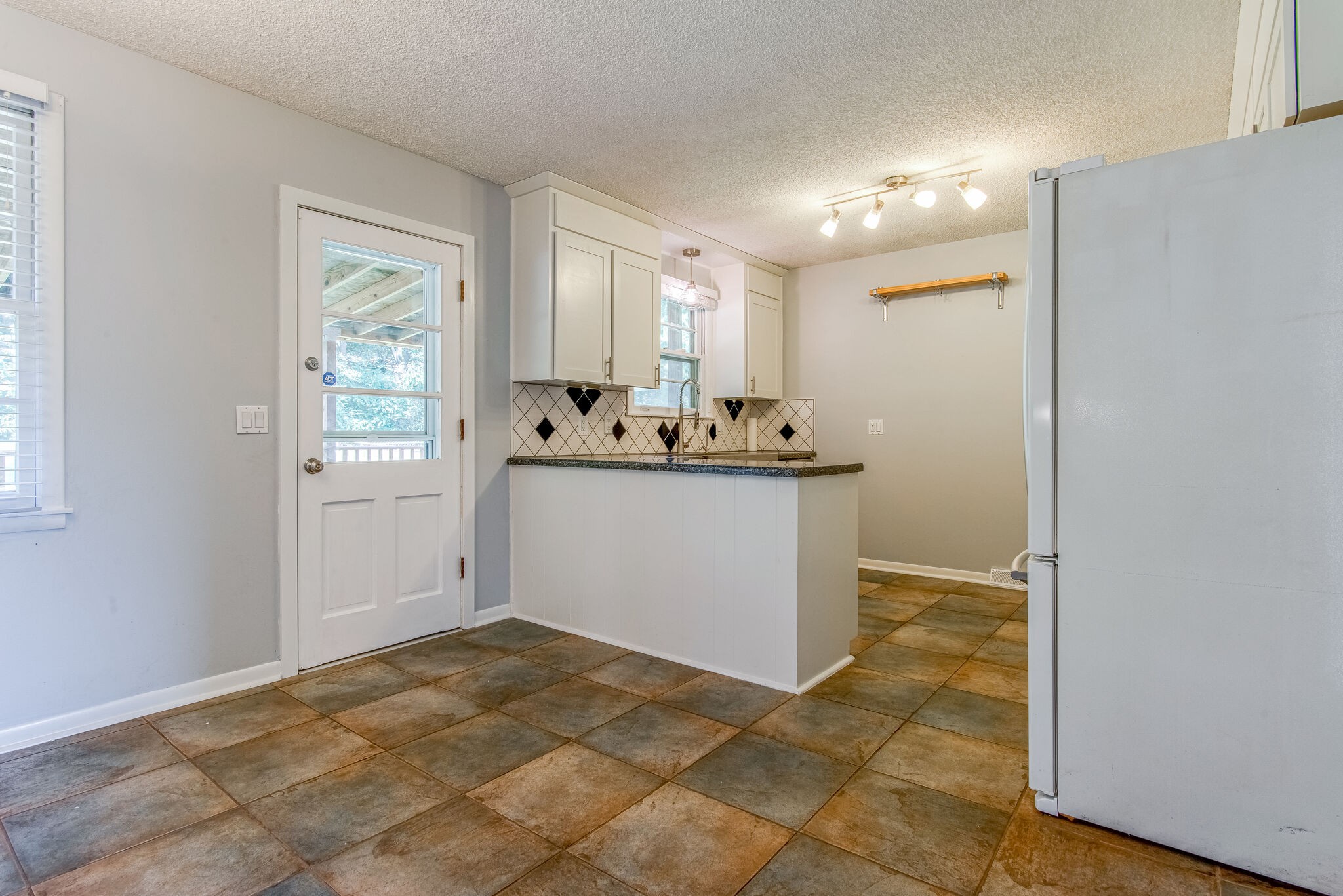561 Rural Hill Road Nashville, TN 37217 - Photo 9 of 32 a view of a sink and a refrigerator a mirror in a room