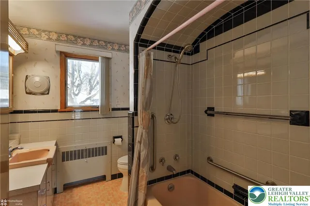 a bathroom with a tub and a shower