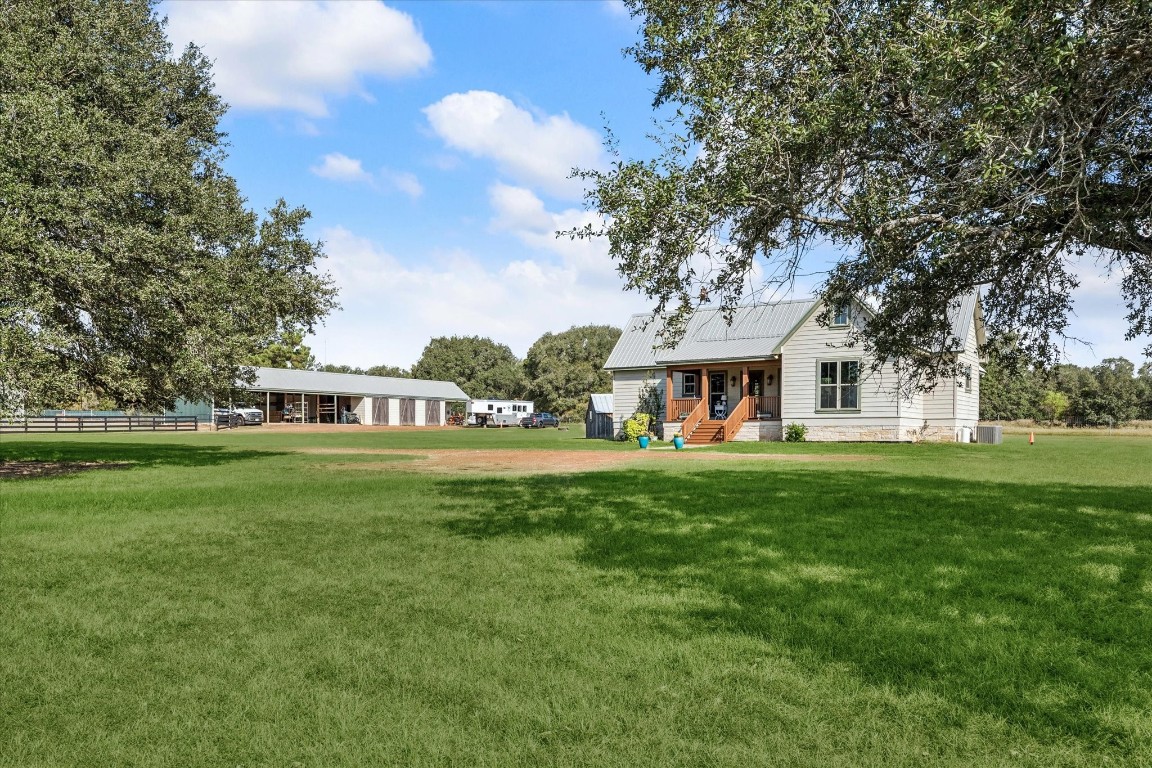 13792 Farm To Market Road 1094 Cat Spring, TX 78933 - Photo 2 of 25 a front view of a house with a garden