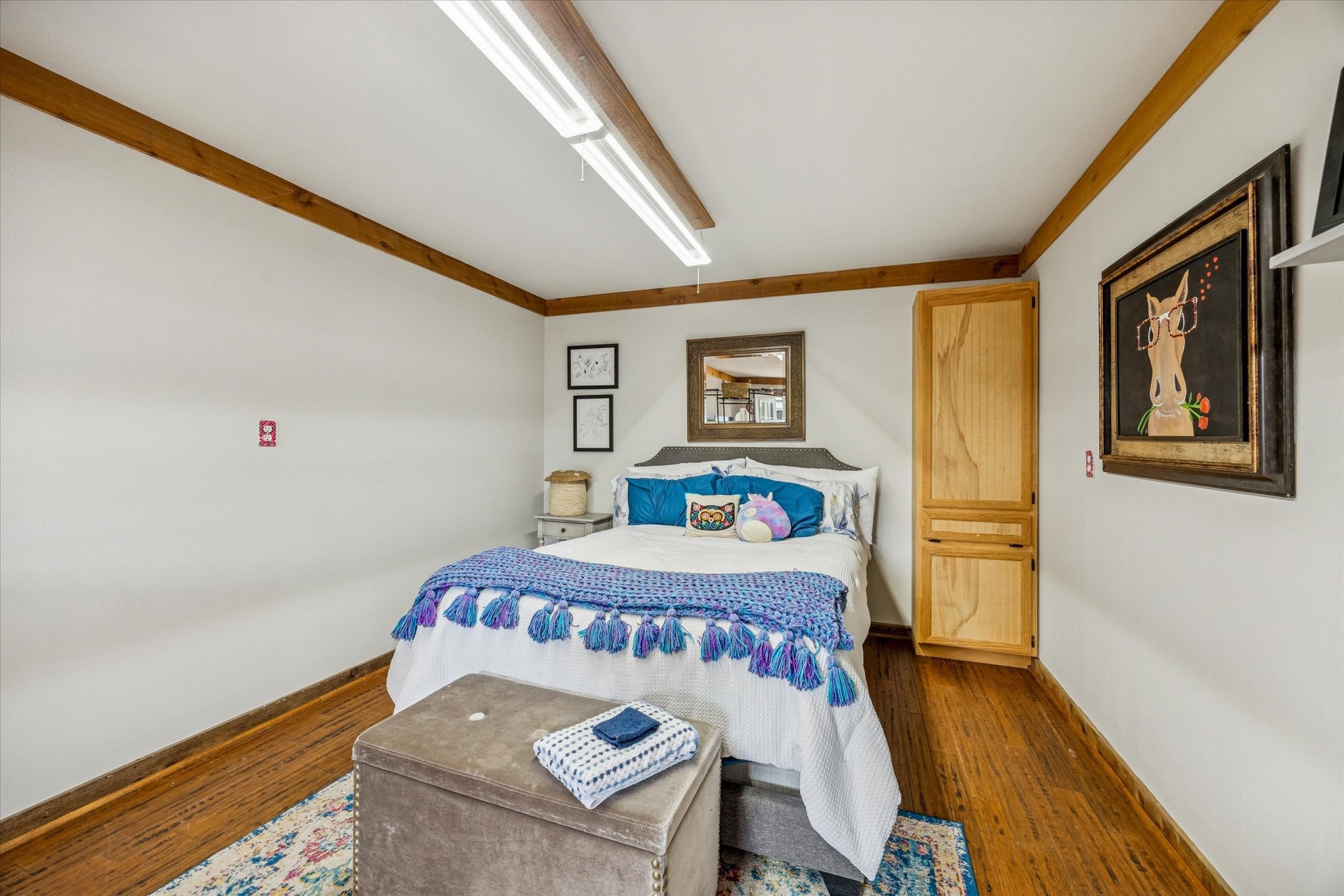 13792 Farm To Market Road 1094 Cat Spring, TX 78933 - Photo 21 of 25 a bedroom with a bed and wooden floor