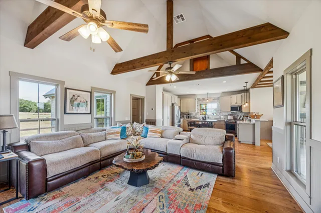a living room with furniture ceiling fan and a rug