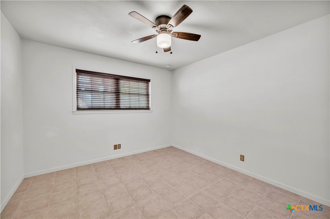 313 Ruggles Loop Temple, TX 76501 - Photo 13 of 22 an empty room with windows and fan