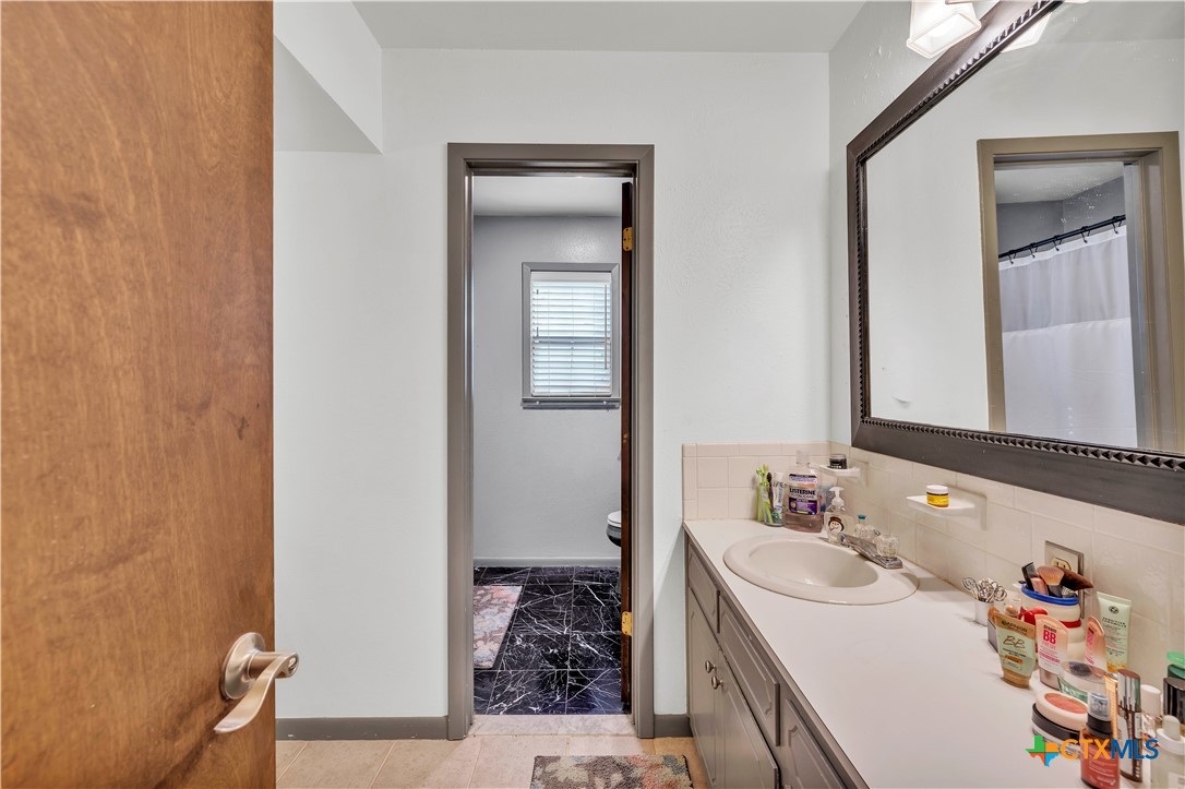 313 Ruggles Loop Temple, TX 76501 - Photo 15 of 22 a bathroom with a sink and a mirror