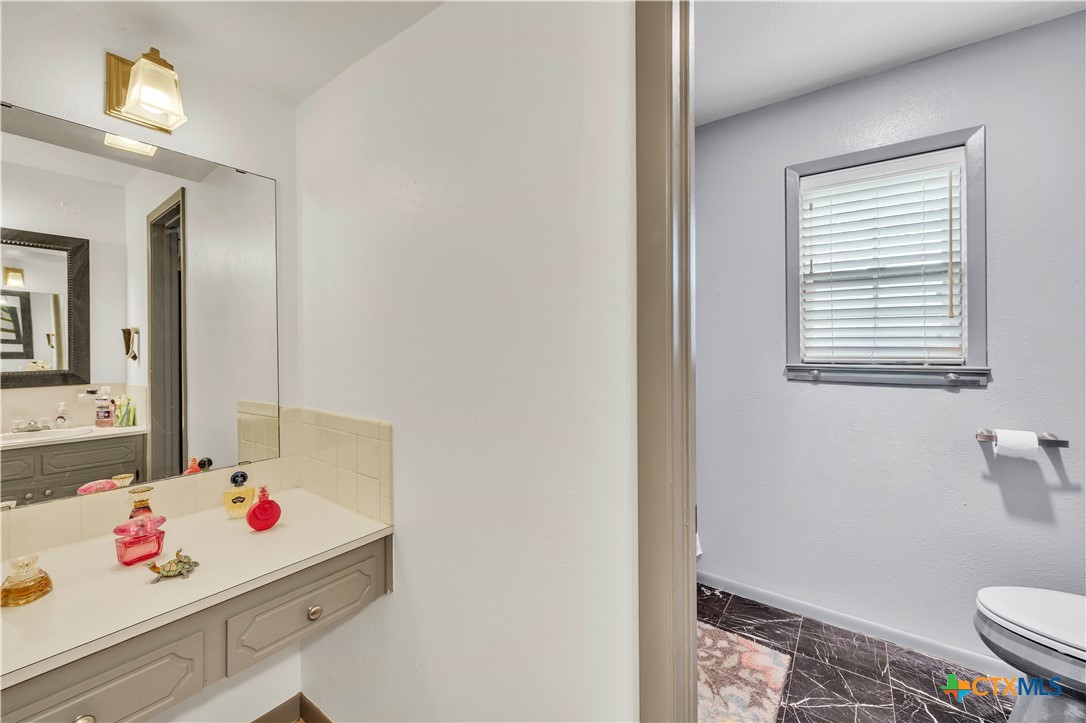 313 Ruggles Loop Temple, TX 76501 - Photo 17 of 22 a bathroom with a sink vanity mirror and toilet