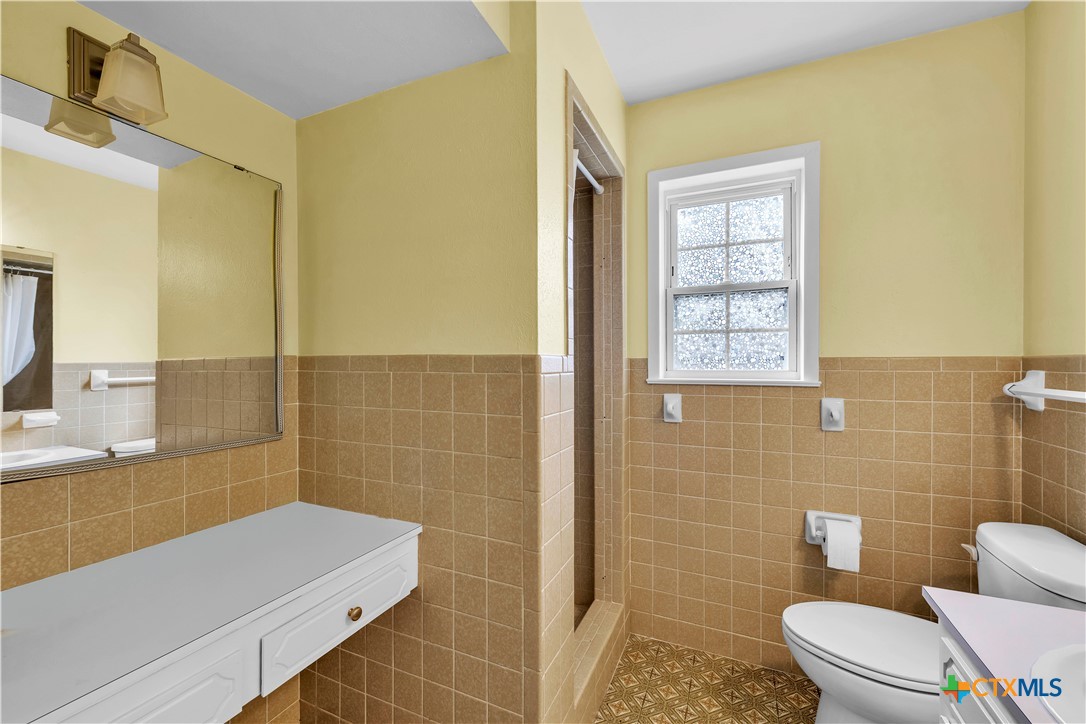 313 Ruggles Loop Temple, TX 76501 - Photo 18 of 22 a bathroom with a sink a toilet and mirror