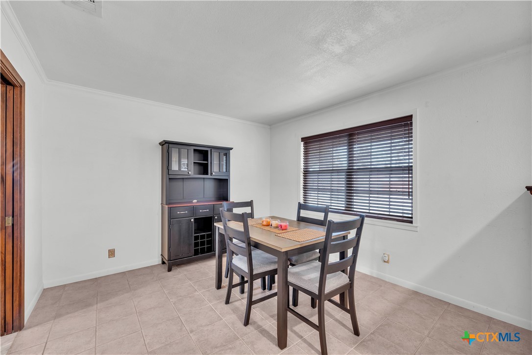 313 Ruggles Loop Temple, TX 76501 - Photo 6 of 22 a dining room with a wooden table and chairs
