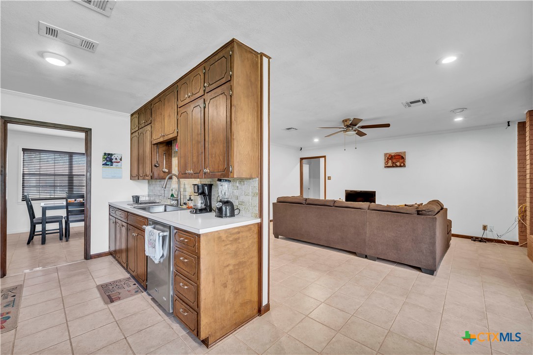 313 Ruggles Loop Temple, TX 76501 - Photo 9 of 22 a large kitchen with stainless steel appliances granite countertop a stove and a sink