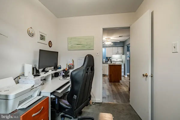 a view of a workspace with furniture and mirror