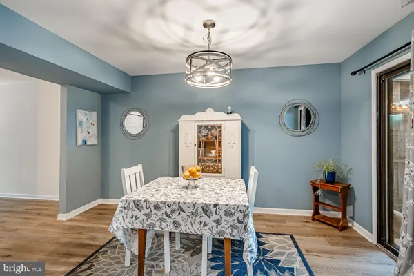 a dining room with furniture a rug and wooden floor