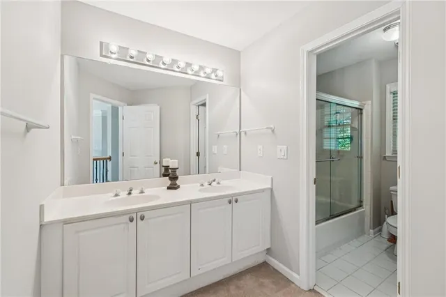a bathroom with a double vanity sink and mirror