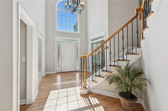 a view of entryway and hall with wooden floor