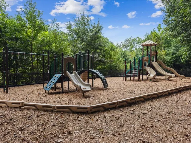 a view of a park with swings and slides