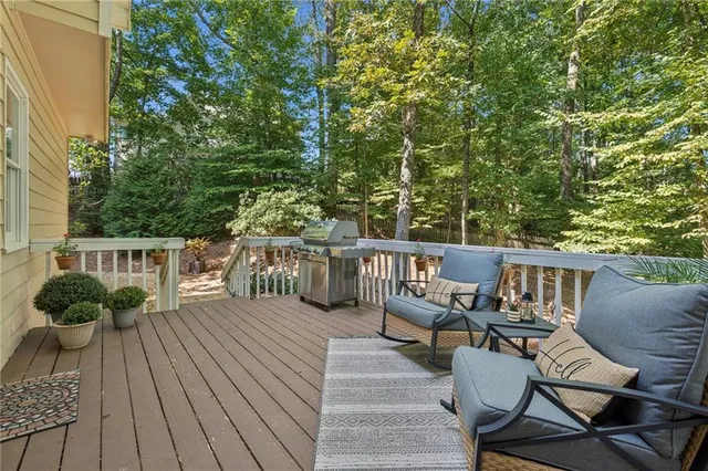 a balcony with wooden floor table and chairs