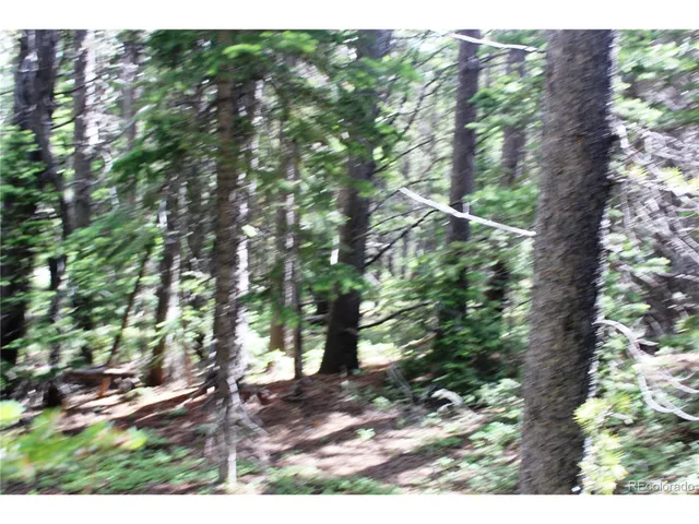 a backyard of a house with a yard and outdoor seating