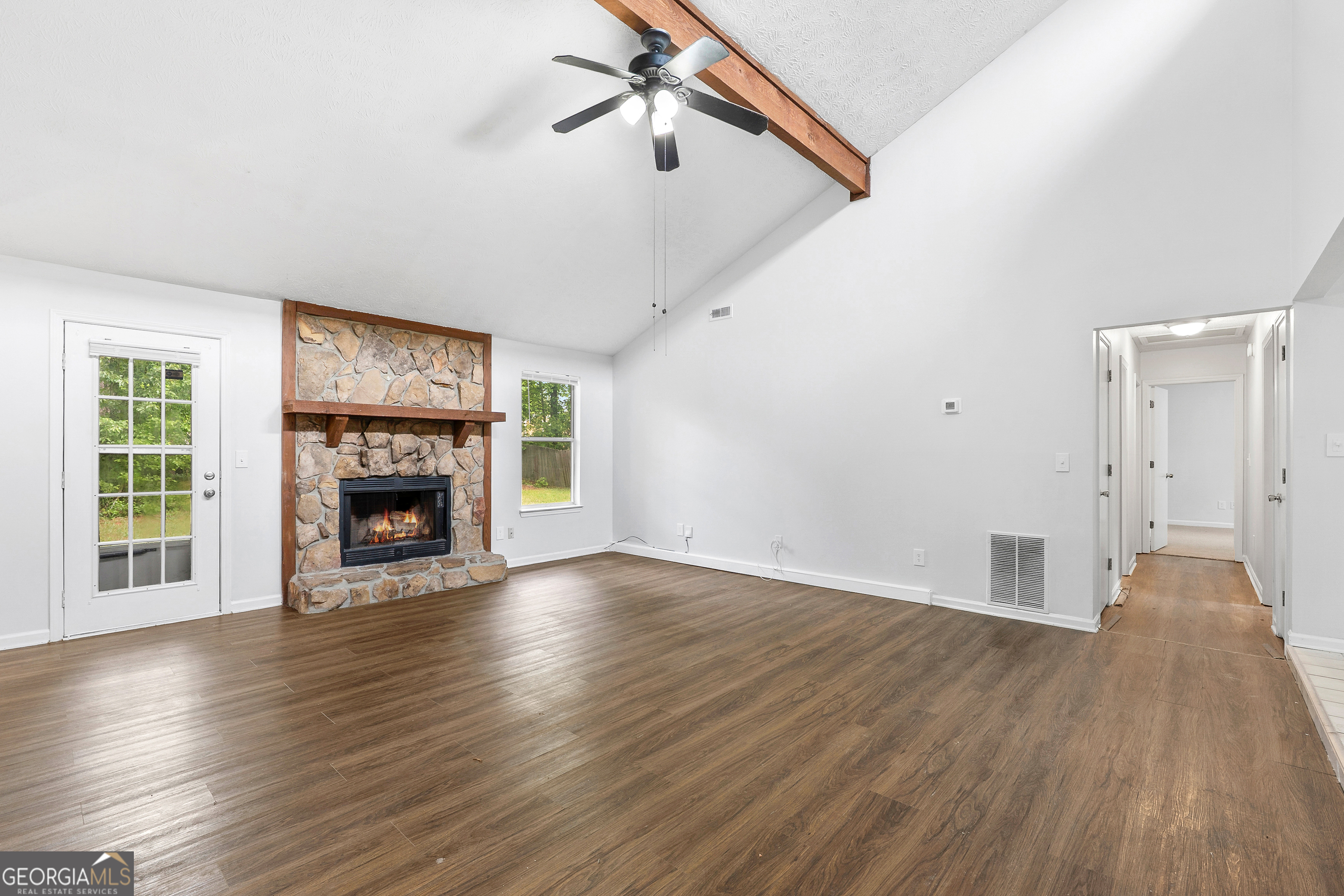 1328 Foxvale Drive Hampton, GA 30228 - Photo 8 of 27 a view of an empty room with wooden floor fireplace and a window