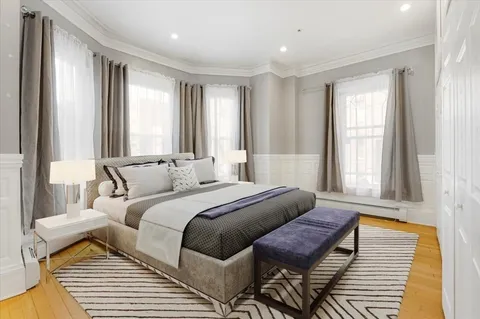 a bedroom with furniture and windows
