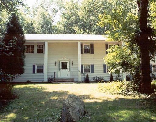 28 Sawmill Road Stamford, CT 06903 - Photo 1 of 1 a view of a yard in front of a house with large tree