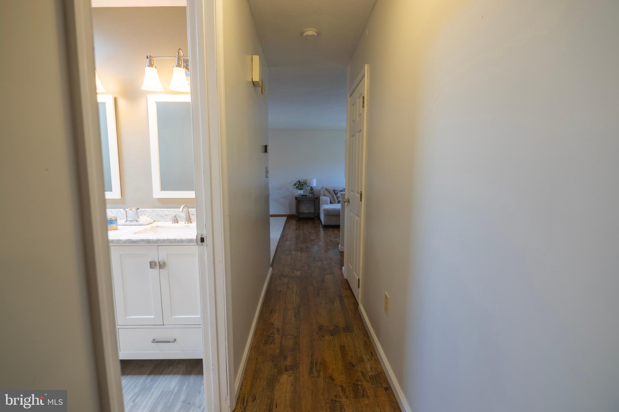 185 Elfner Road Red Lion, PA 17356 - Photo 25 of 34 a view of a hallway with wooden floor and a bathroom