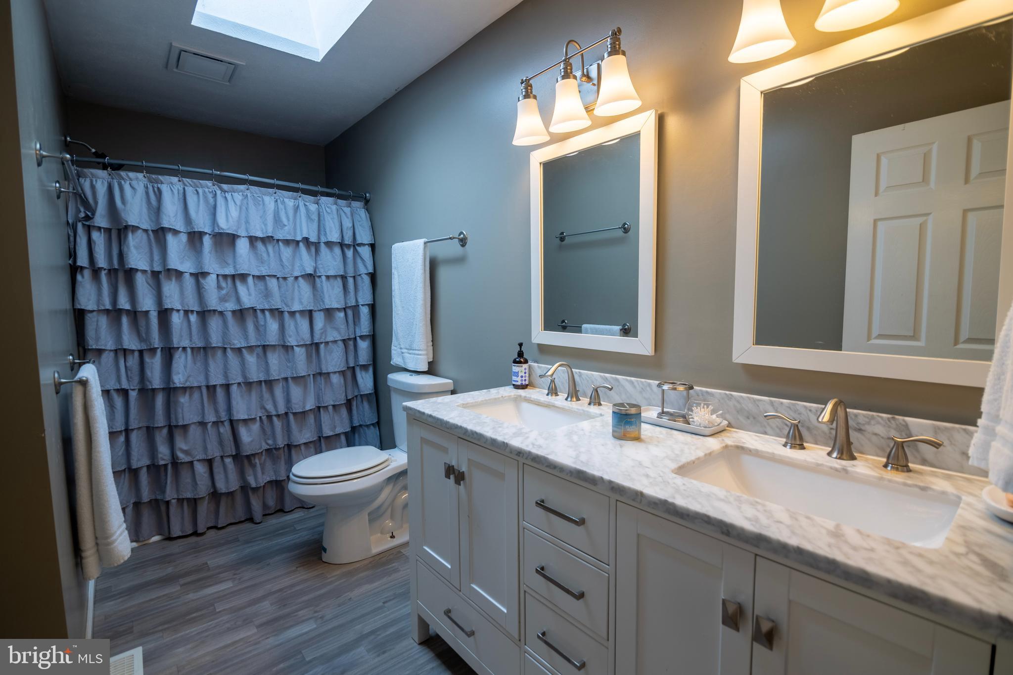 185 Elfner Road Red Lion, PA 17356 - Photo 26 of 34 a bathroom with a double vanity sink toilet and shower