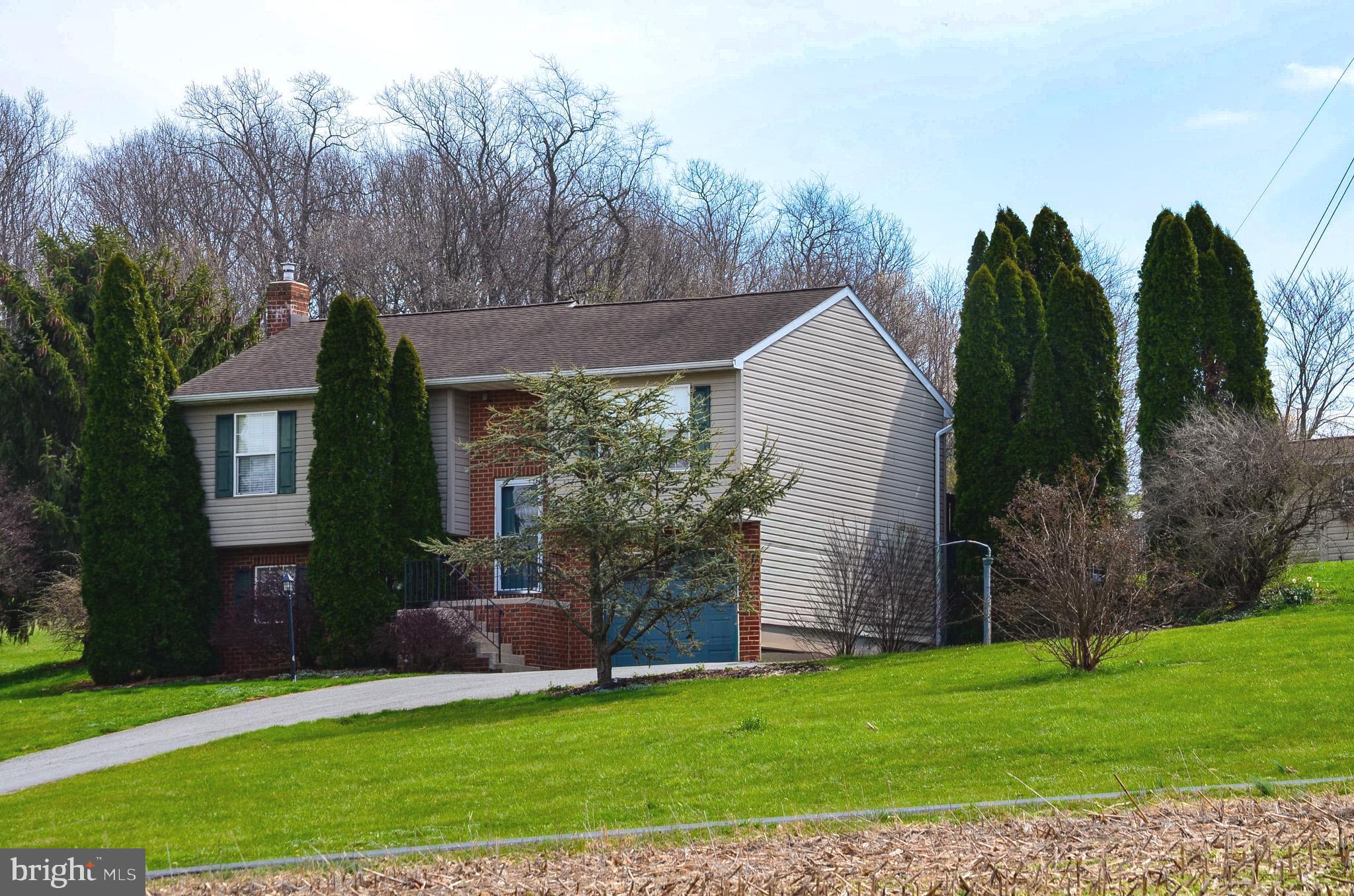 185 Elfner Road Red Lion, PA 17356 - Photo 5 of 34 a front view of a house with a garden