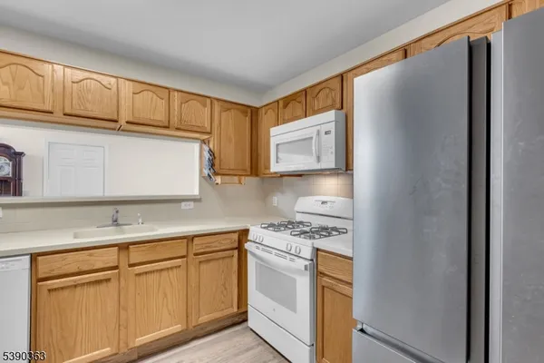 a kitchen with stainless steel appliances granite countertop a refrigerator sink and cabinets