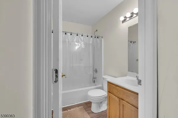 a bathroom with a shower a toilet and a sink