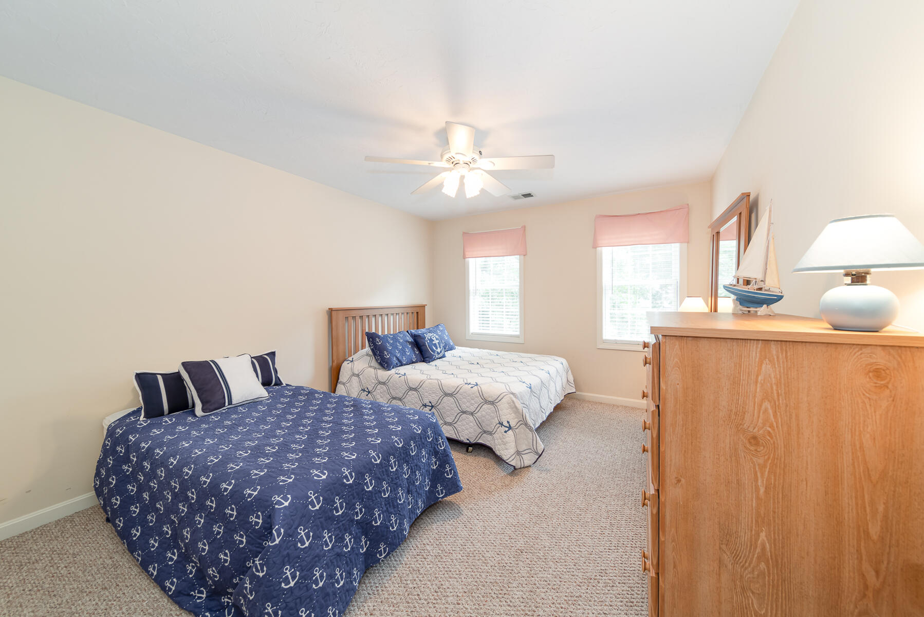 15 Nehoiden Road Mashpee, MA 02649 - Photo 16 of 40 a bedroom with bed and a chandelier