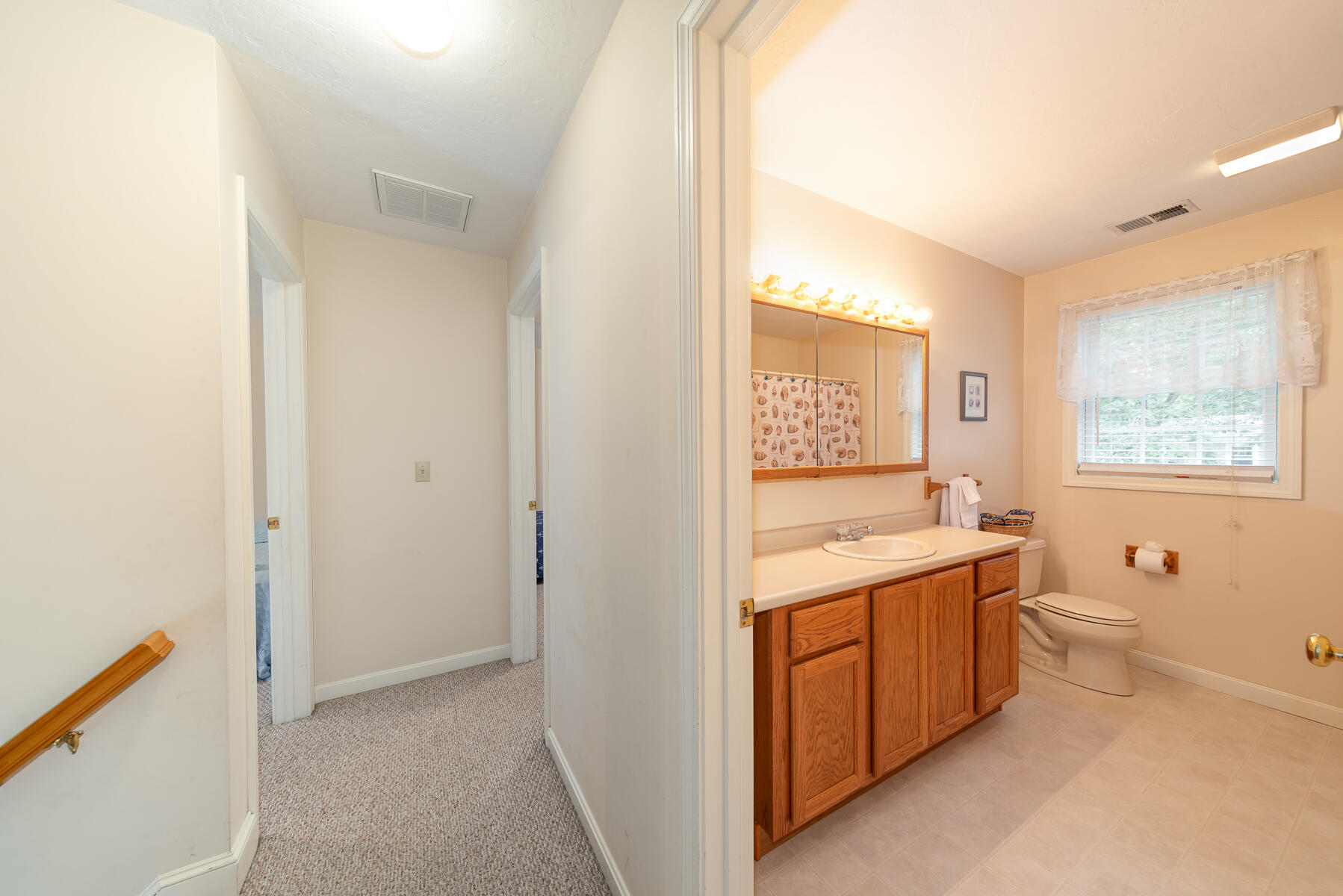15 Nehoiden Road Mashpee, MA 02649 - Photo 17 of 40 a bathroom with a granite countertop toilet sink and mirror