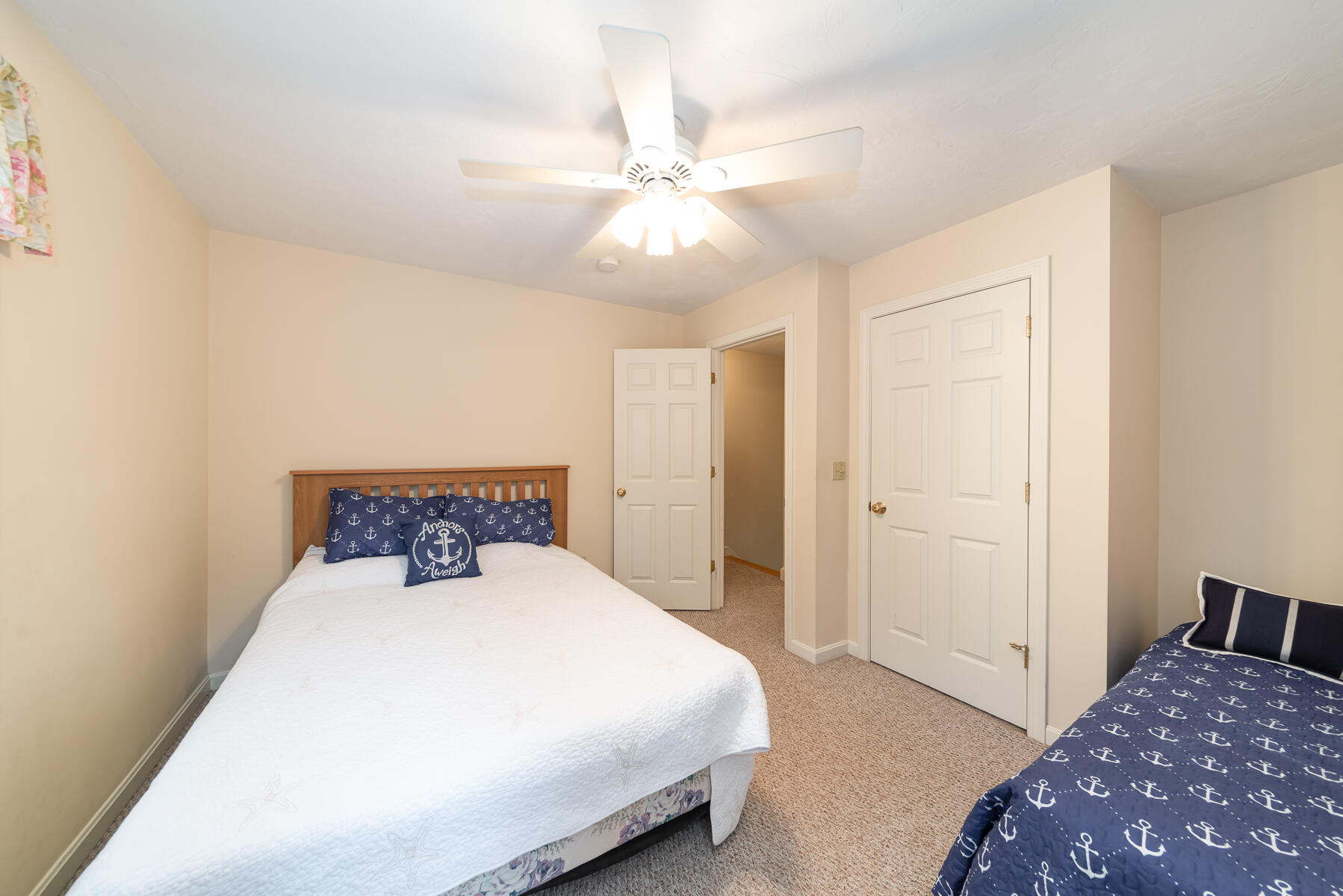 15 Nehoiden Road Mashpee, MA 02649 - Photo 18 of 40 a bedroom with a bed and a chandelier