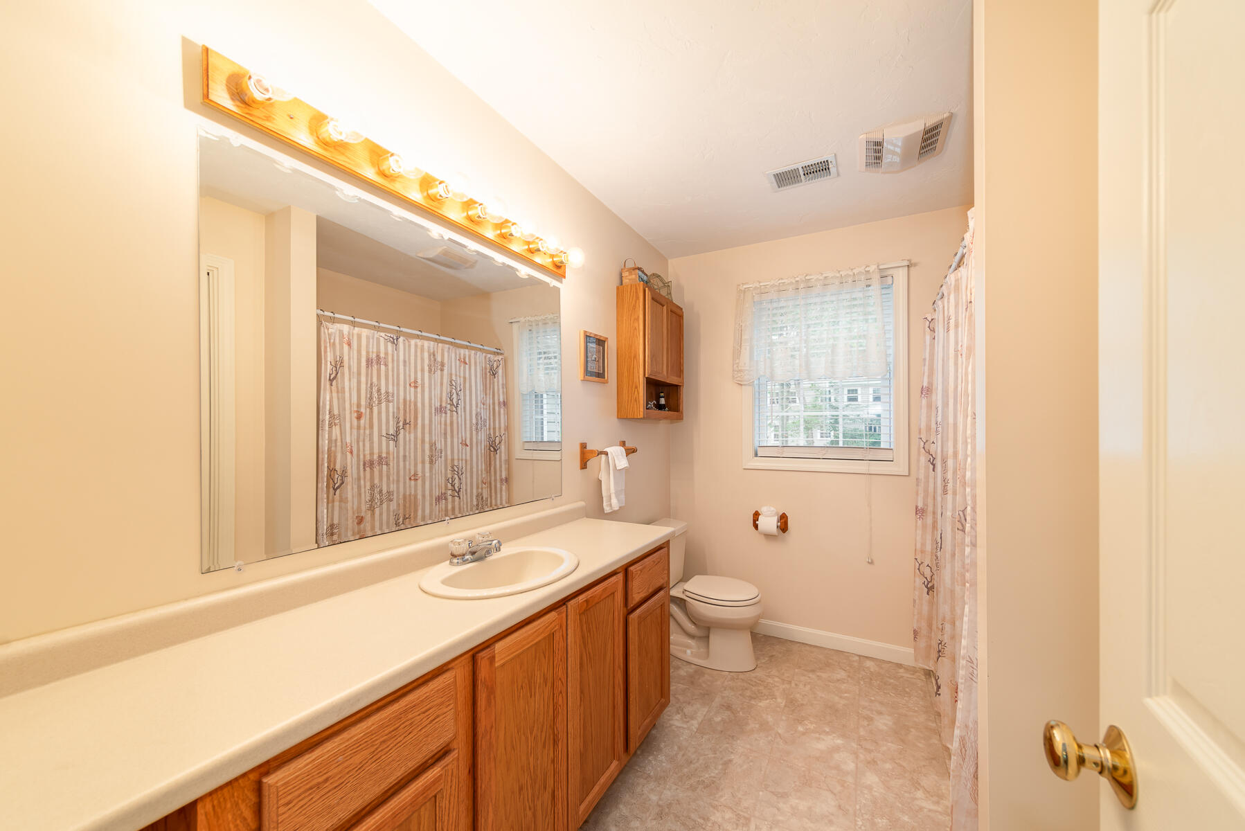15 Nehoiden Road Mashpee, MA 02649 - Photo 26 of 40 a bathroom with a double vanity sink toilet mirror and shower