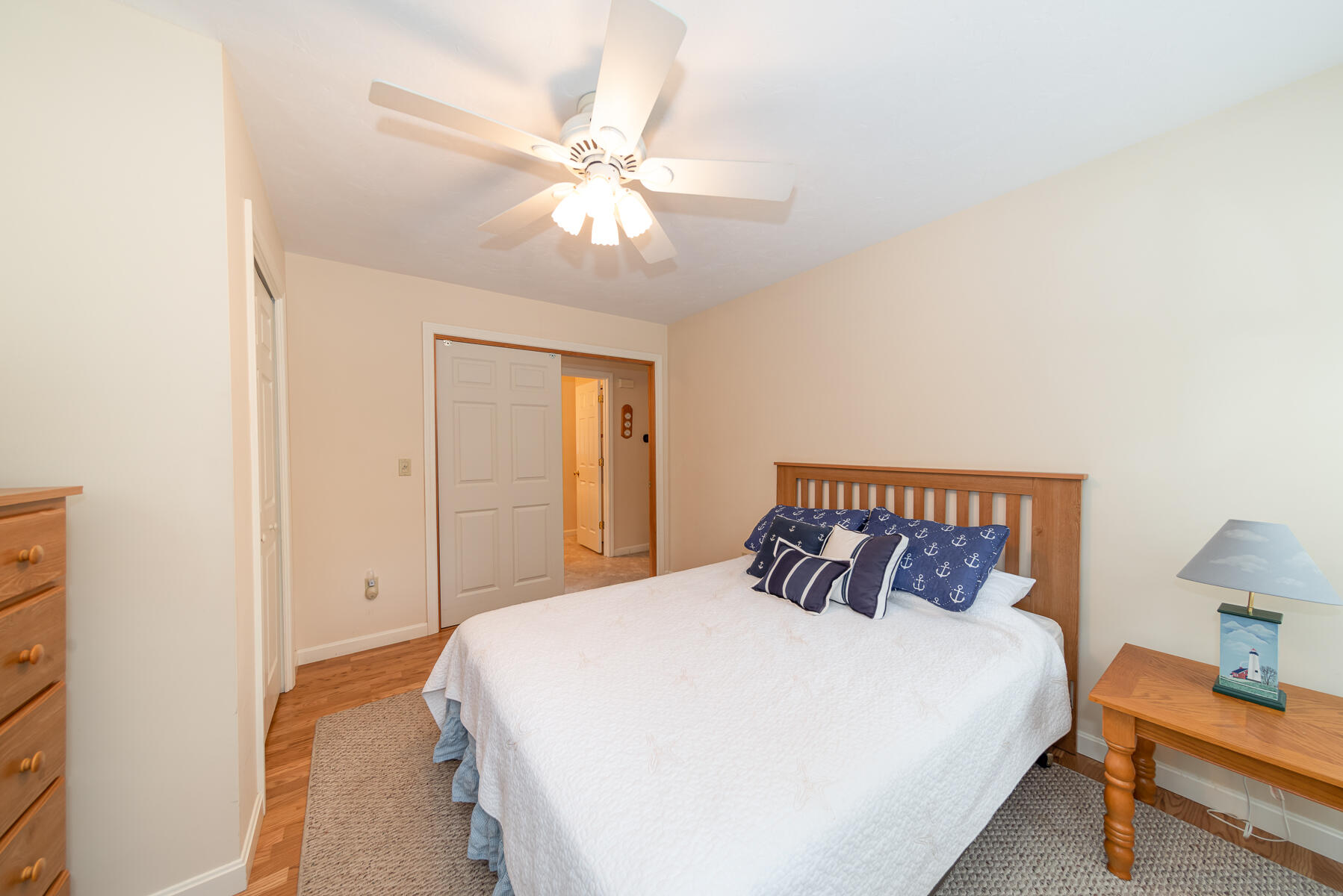 15 Nehoiden Road Mashpee, MA 02649 - Photo 28 of 40 a bedroom with a bed and a chandelier