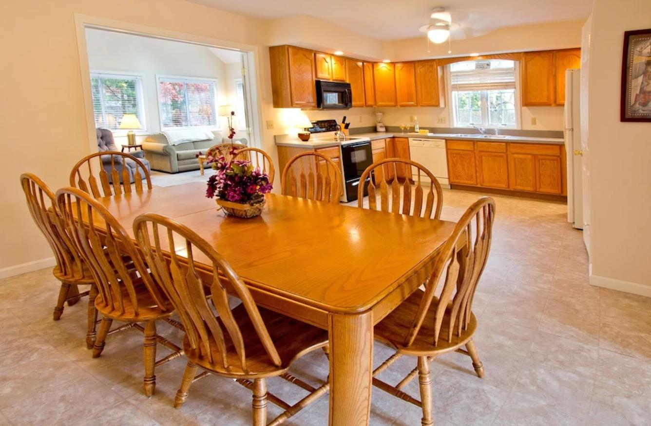 15 Nehoiden Road Mashpee, MA 02649 - Photo 3 of 40 a dining room with furniture a large window and plants