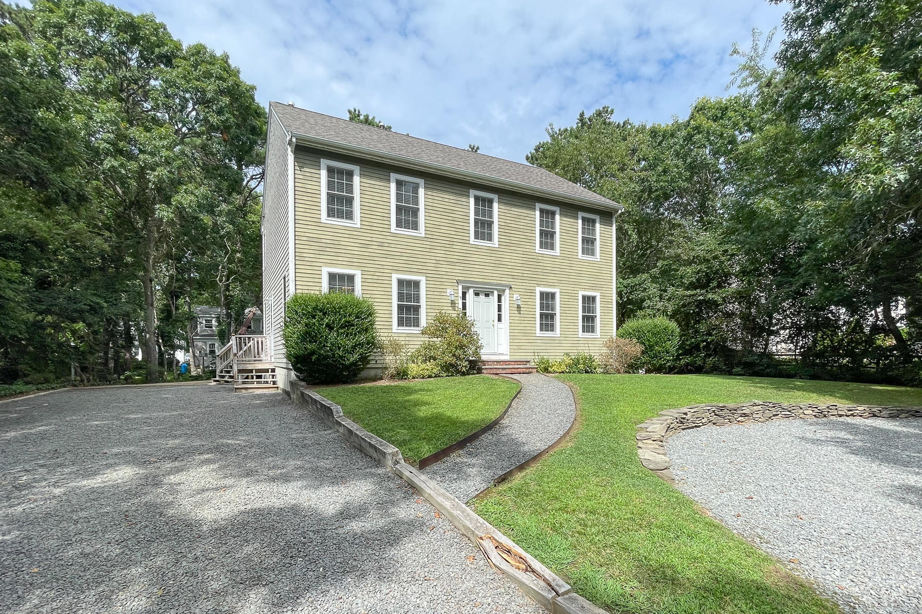 15 Nehoiden Road Mashpee, MA 02649 - Photo 8 of 40 a front view of a house with a yard and garage